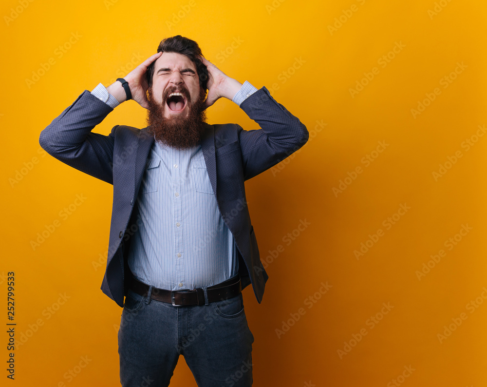Bearded man holds his head with both hands. Problems. Lack of time. Do not go business. Bearded man holds his head with both hands. Problems. Lack of time. Do not go business.
