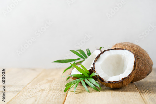 Fresh coconut with leaves on white background