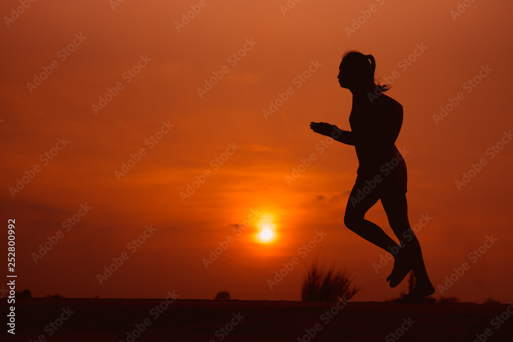 young fitness woman running on sunset seaside trail - Image