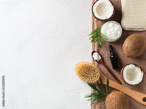 Dry massage brush with coconuts oil, health wellness concept with accessories on white background