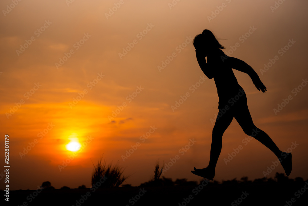 young fitness woman running on sunset seaside trail - Image