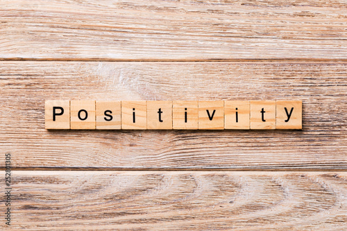 positivity word written on wood block. positivity text on wooden table for your desing, concept photo