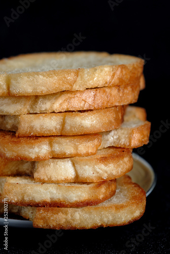 White toasted bread stacked in a pile on a plate. Shallow depth of field