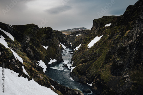 remote Canyon of Troll waterfall Iceland  in the winter with snow 