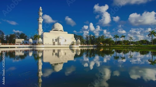 Timelapse of Beautiful White mosque with reflection in the lake photo