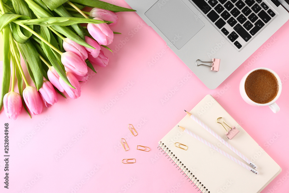 Stylish stationery with laptop, cup of coffee and tulips on color background Stylish stationery with laptop, cup of coffee and tulips on color background