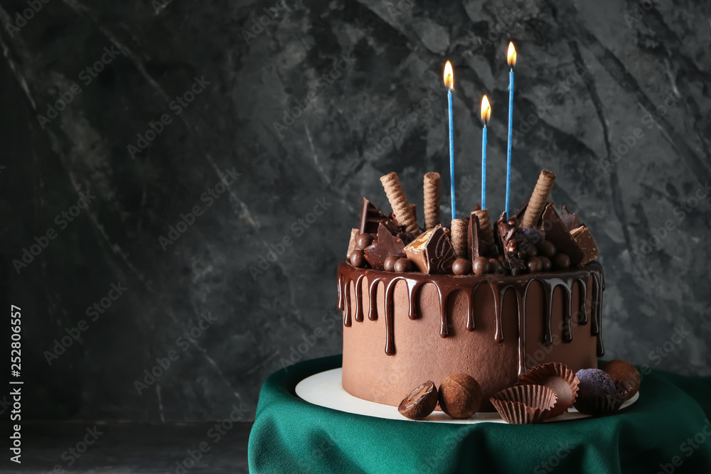 Birthday chocolate cake with candles on grey background Stock Photo