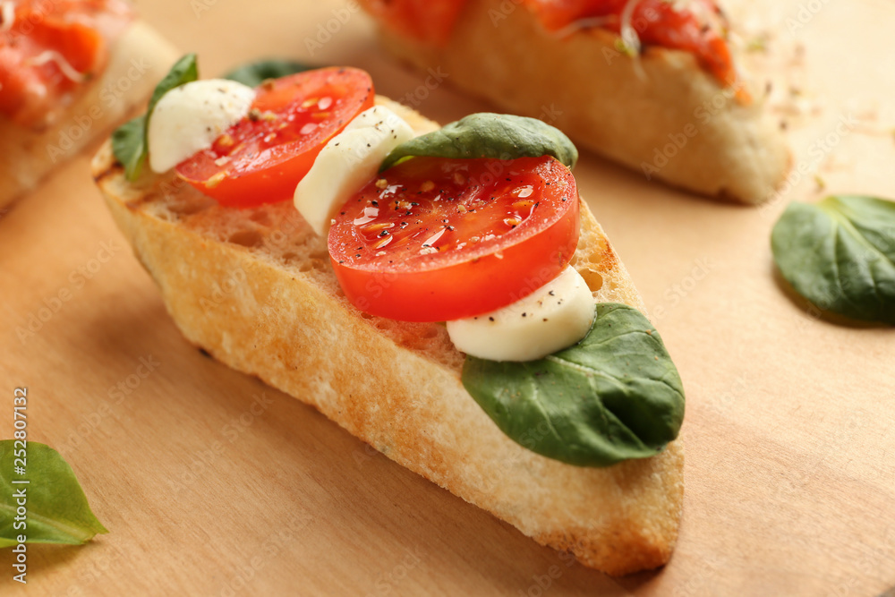 Fresh tasty bruschetta on wooden board, closeup Fresh tasty bruschetta on wooden board, closeup