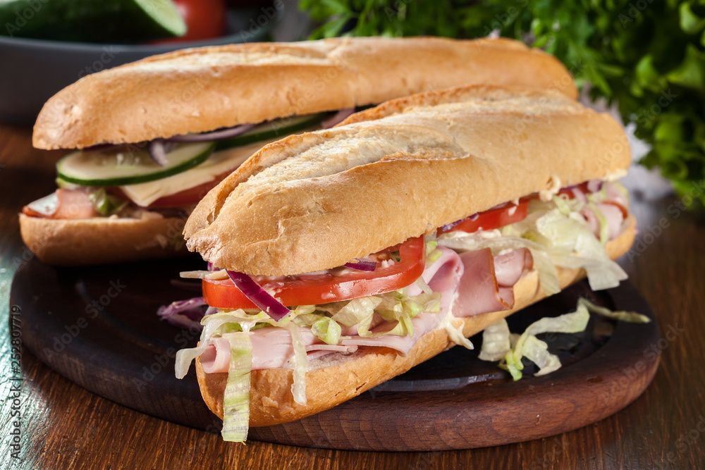 Submarine sandwiches with ham, cheese and vegetables Submarine sandwiches with ham, cheese and vegetables