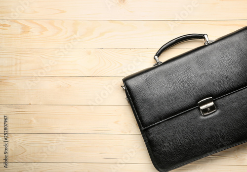 Male briefcase on wooden background