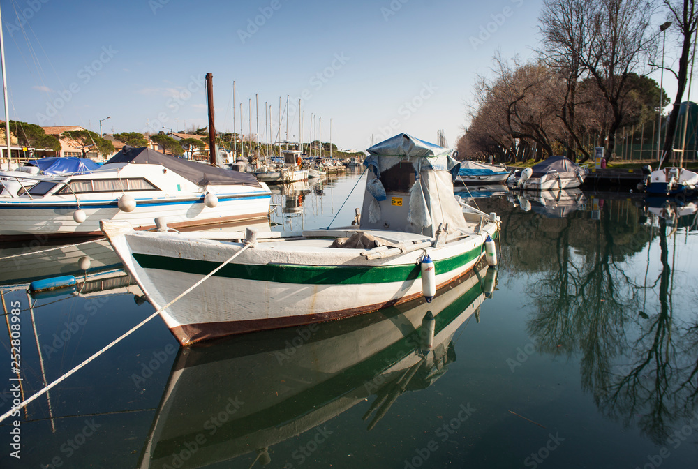 Boat docked in the Villaggio del Pescatore dock