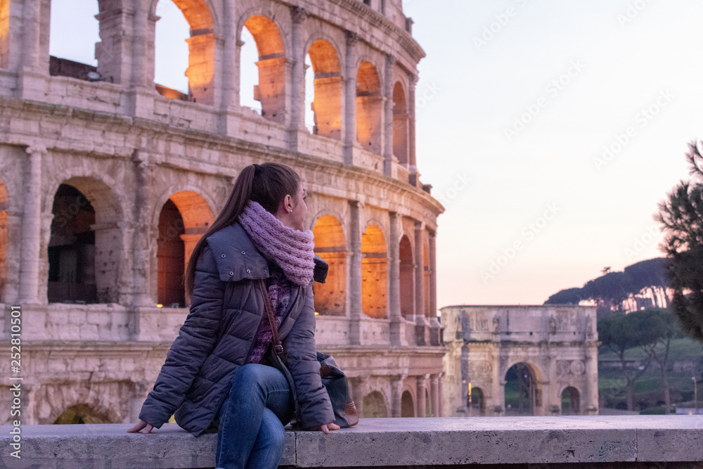 Rome/Italy 21 february 2019 :woman standing in front of colosseo in Rome he admires the greatness of this landmark