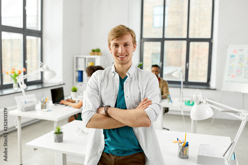 business and people concept - man with crossed hands at office business and people concept - man with crossed hands at office