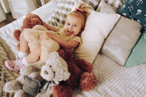 happy little girl posing with teddy bear 