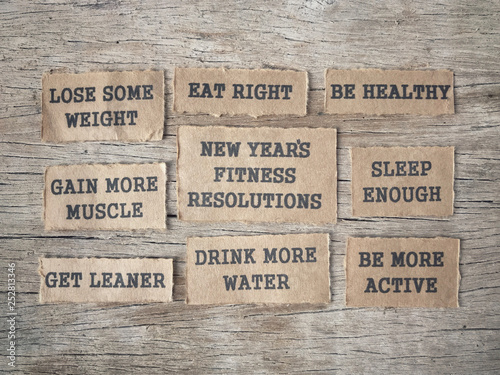 Wallpaper Mural New Year Fitness Resolutions concept - New Year’s Fitness Resolutions and list written on papers and arranged on wooden table. Torontodigital.ca