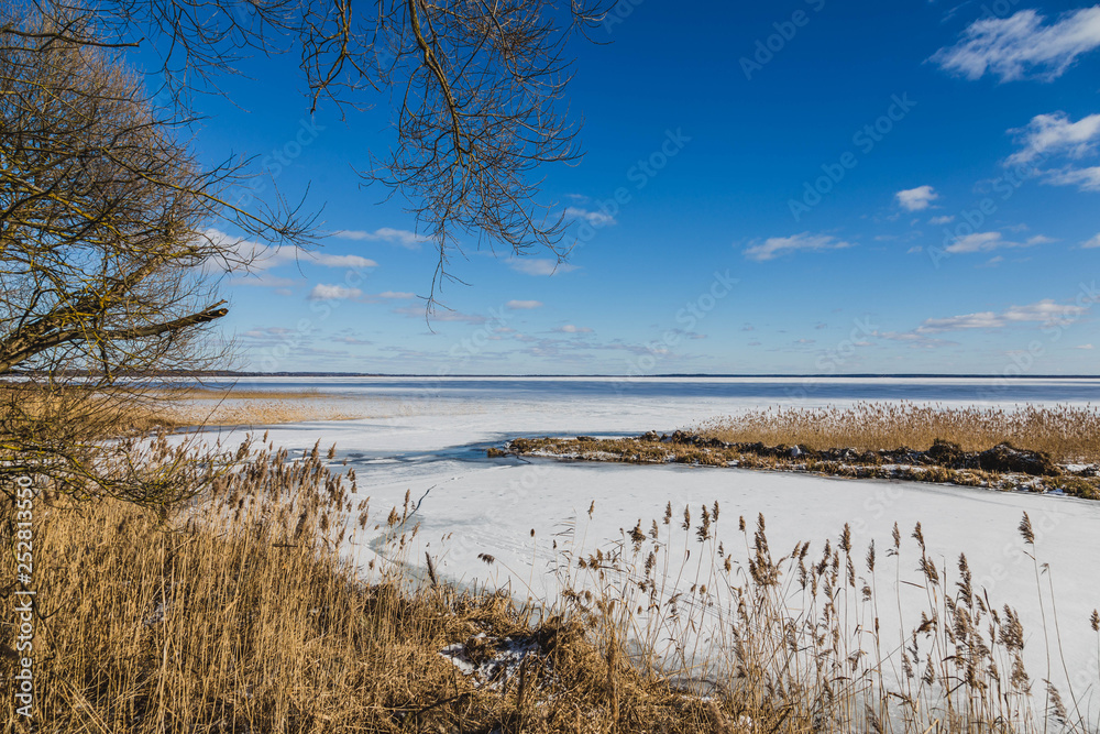 Winter landscape with frozen lake in clear weather Winter landscape with frozen lake in clear weather