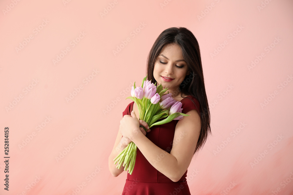 Young woman with bouquet of flowers on color background. 8 March celebration Young woman with bouquet of flowers on color background. 8 March celebration
