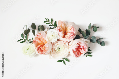 Fototapeta Floral arrangement, web banner with pink English roses, ranunculus, carnation flowers and green leaves on white table background