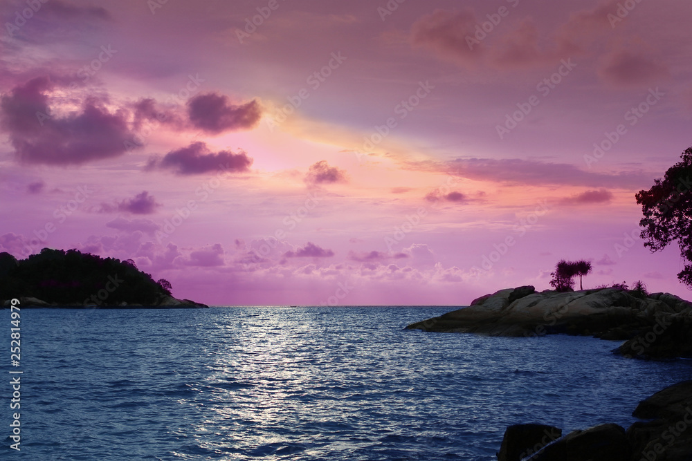 Romantic seascape in a beautiful turquoise sea at sunset on the background of small islands, Malaysia, island, Malacca Strait, concept of vacation, travel.