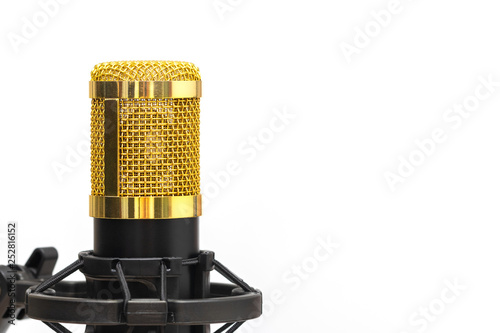 Close-up condenser gold microphone with luxurious. Composition on the left side with free space on the right isolated on white background.