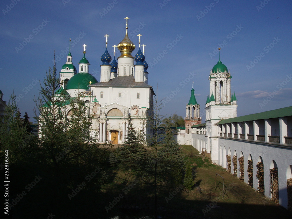 View of the Church courtyard with green trees and cathedrals with colored domes from the fortress wall
