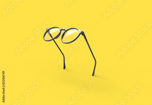 Studio shot of flying Black glasses on yellow background photo
