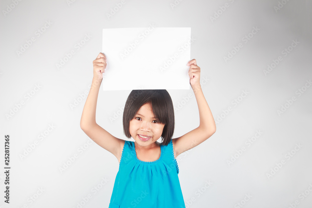 Little asian girl holding white paper and space for text Little asian girl holding white paper and space for text