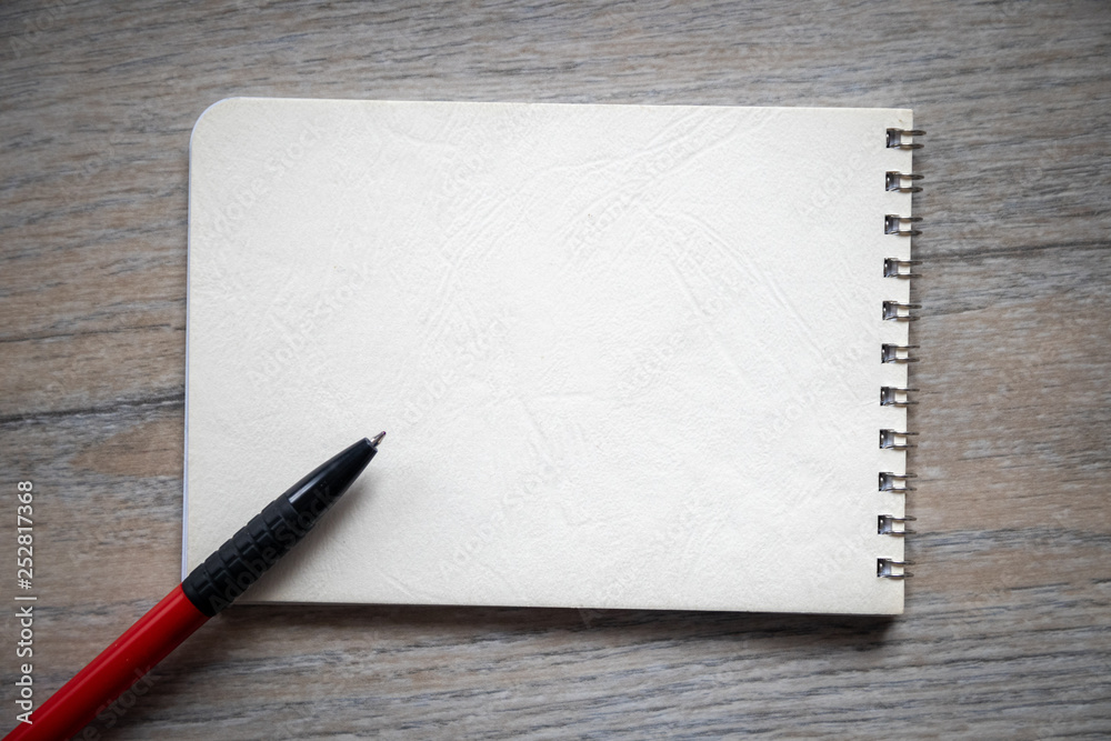 School notebook with pen on wooden table with copy space School notebook with pen on wooden table with copy space