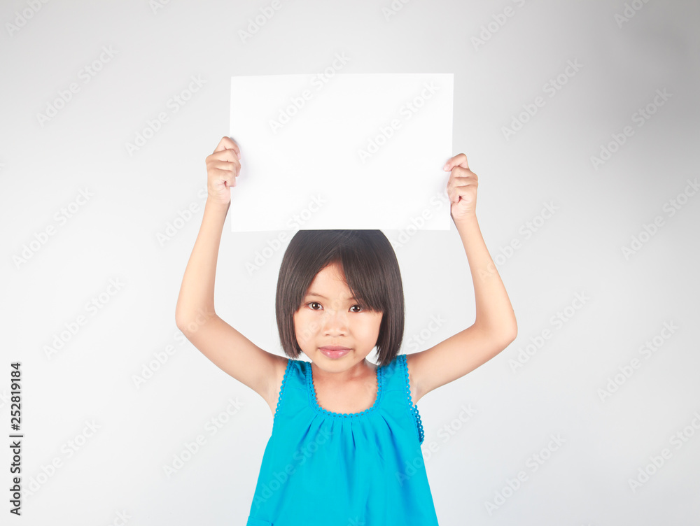 Little asian girl holding white paper and space for text Little asian girl holding white paper and space for text