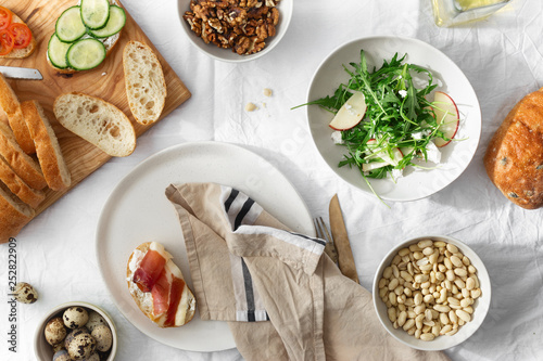 Healthy breakfast lunch snack Sandwiches prosciutto vegetables arugula salad background top view photo