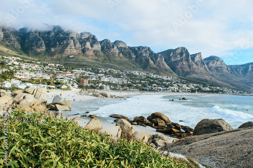 Camps Bay beach on a sunny summer day seen from the boulders of Maiden's Cove
