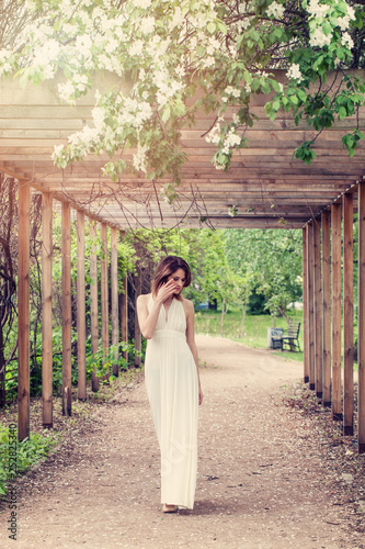 Spring woman in white fashionable dress outdoors portrait, romantic dreams