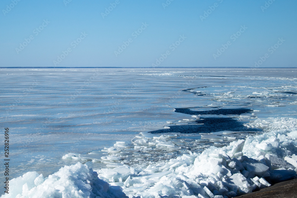 Ice and thawed patches in ice on a reservoir on a winter day Ice and thawed patches in ice on a reservoir on a winter day
