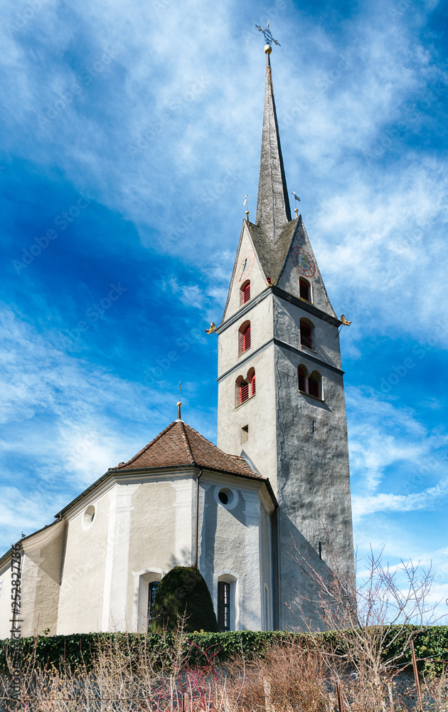 small white European church in a Swiss alpine village in the Grisons small white European church in a Swiss alpine village in the Grisons