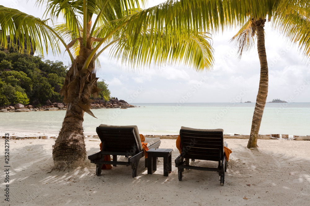 Tropical landscape view with deckchairs at Praslin island, Seychelles