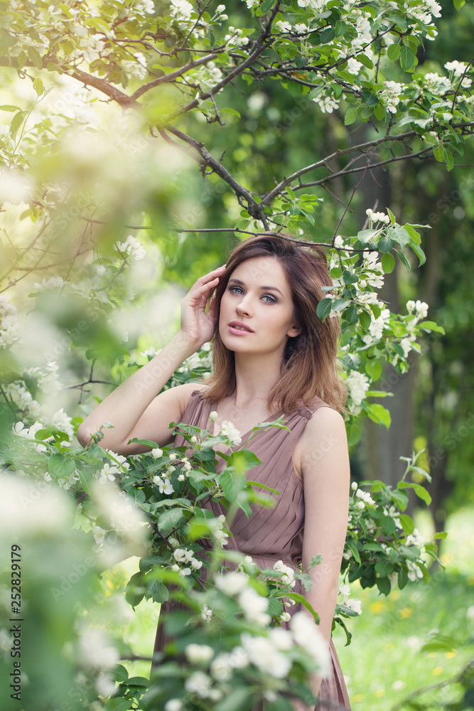 Pretty woman in spring. Beautiful girl on floral nature background, lifestyle portrait Pretty woman in spring. Beautiful girl on floral nature background, lifestyle portrait