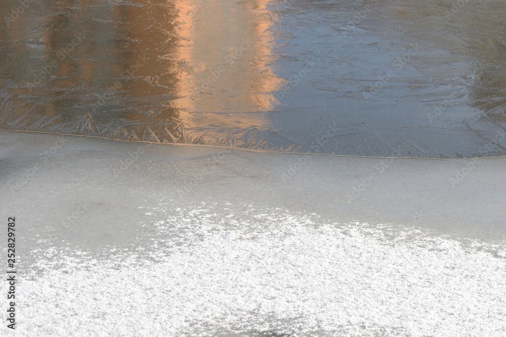 Fototapeta premium Snow and ice on a winter river. Winter texture and background