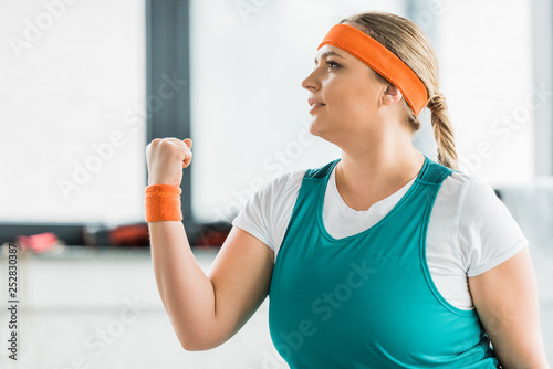 plus size girl in sportswear workouting in gym