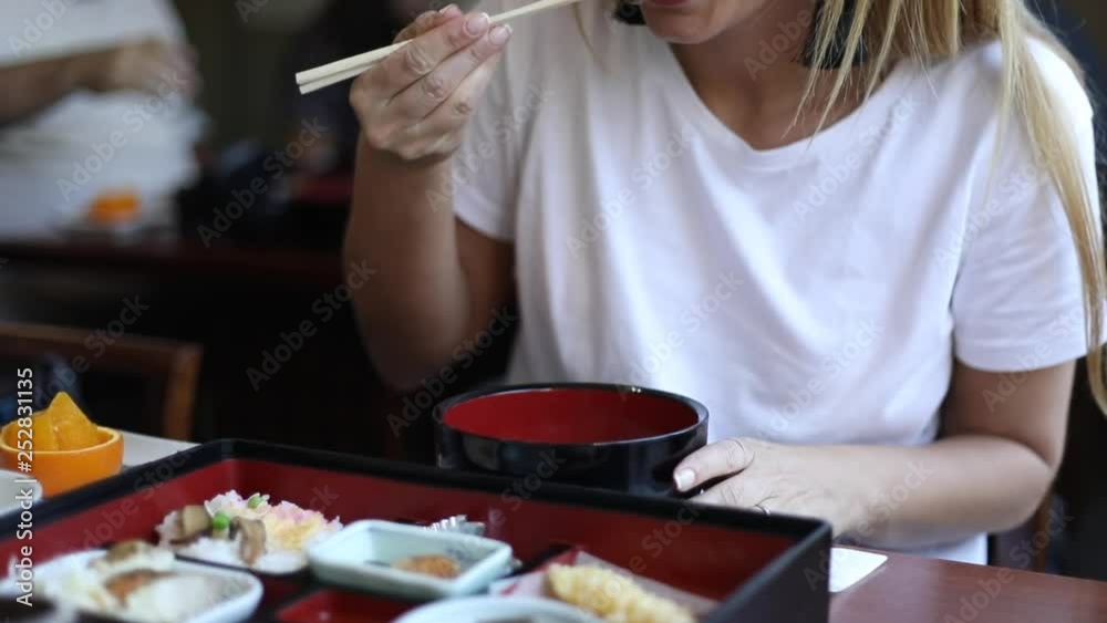 woman eating traditional japanese food woman eating traditional japanese food