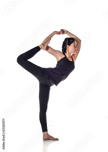 Attractive young woman doing Natarajasana exercise, Lord of the Dance pose,   practicing yoga, working out at home or in yoga studio, isolated on white background, with clipping path - Image photo