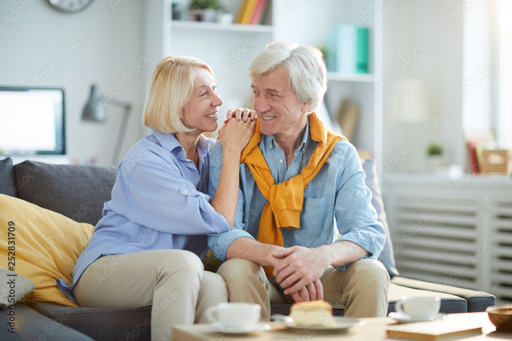 Portrait of loving senior couple looking t each other while enjoying tea at home, copy space Portrait of loving senior couple looking t each other while enjoying tea at home, copy space