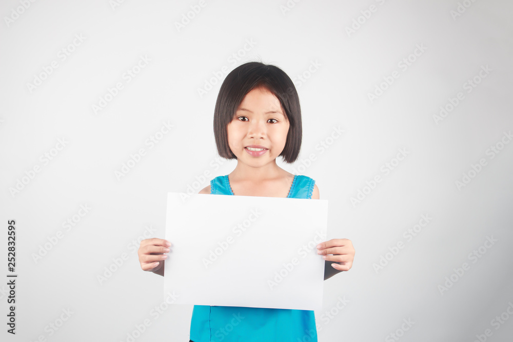 Little asian girl holding empty white paper and space for text Little asian girl holding empty white paper and space for text
