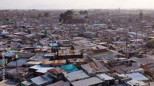 Aerial over ramshackle tin roofs of Gugulethu, one of the poverty stricken slums, ghetto, or townships of South Africa. photo