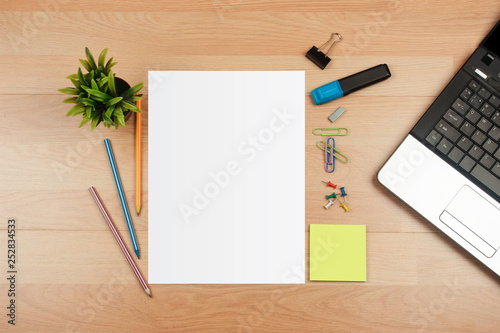 White template paper with office supplies on wooden desk