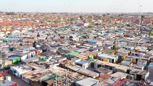 Aerial over contrasting townships of South Africa, with poverty stricken slums, streets and ghetto buildings. photo