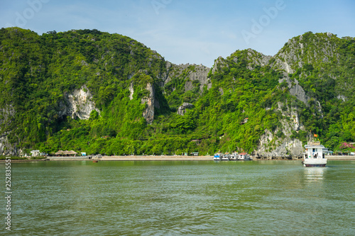 Beautiful travel view in the Halong Bay Vietnam landscape ocean and limestone mountain on blue sky background photo