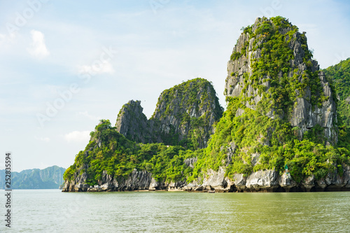 Beautiful travel view in the Halong Bay Vietnam landscape ocean and limestone mountain on blue sky background