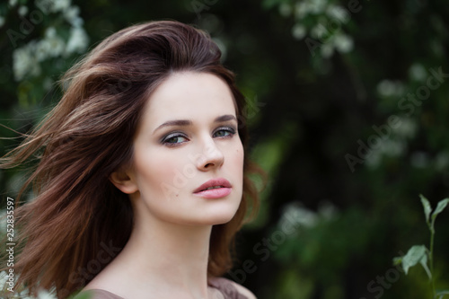 Closeup portrait of young woman face outdoors