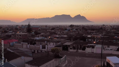 Spectacular aerial over township in South Africa, vast poverty and ramshackle huts, at night or dusk.