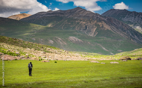 Lonely man trekking with big mountain